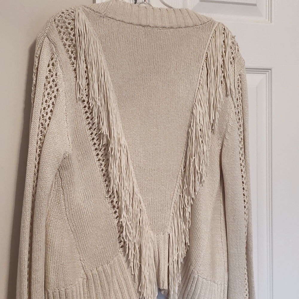 Off white cardigan with fringed back.